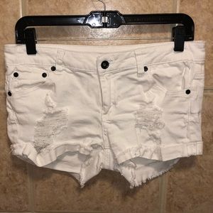 White distressed jean shorts.